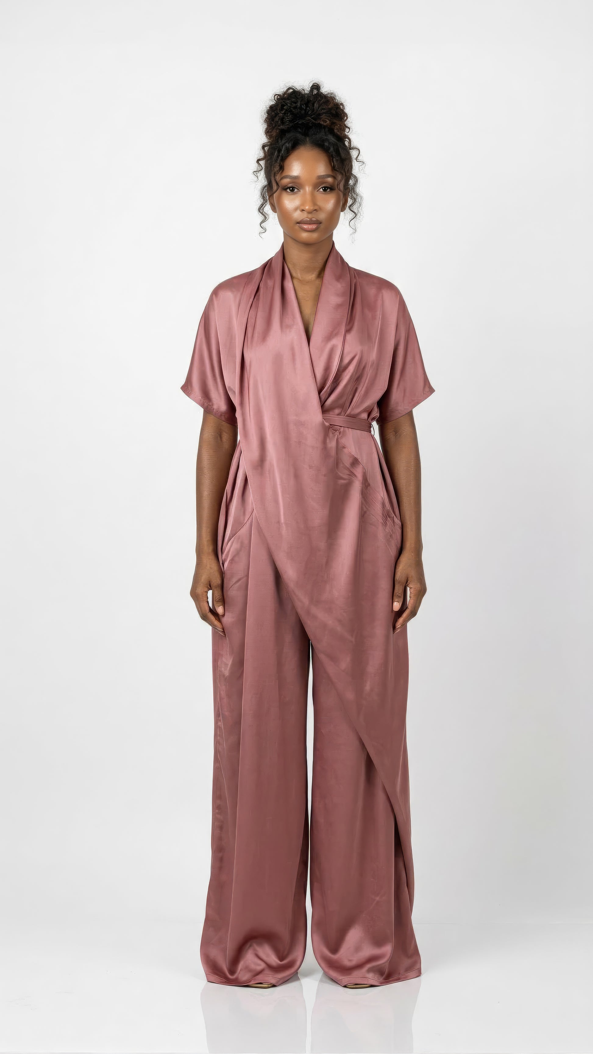 Dusty rose Anisah Jumpsuit from Nahota Kanma, made from Duchess Satin with wide-leg, draped neckline and batwing sleeves.